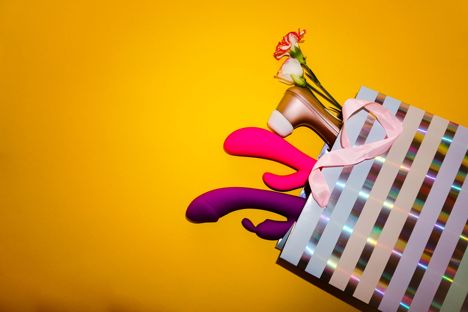 Hand holding a fresh lemon on soft pink background, symbolizing the shift in sensation during menopause